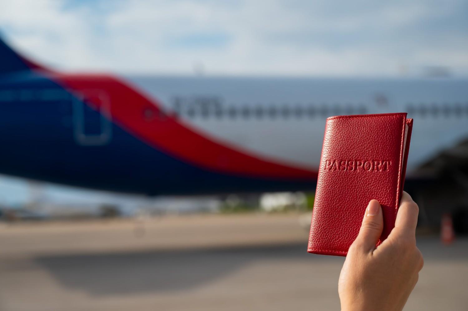 A Woman Gets On A Plane And Holds A Passport