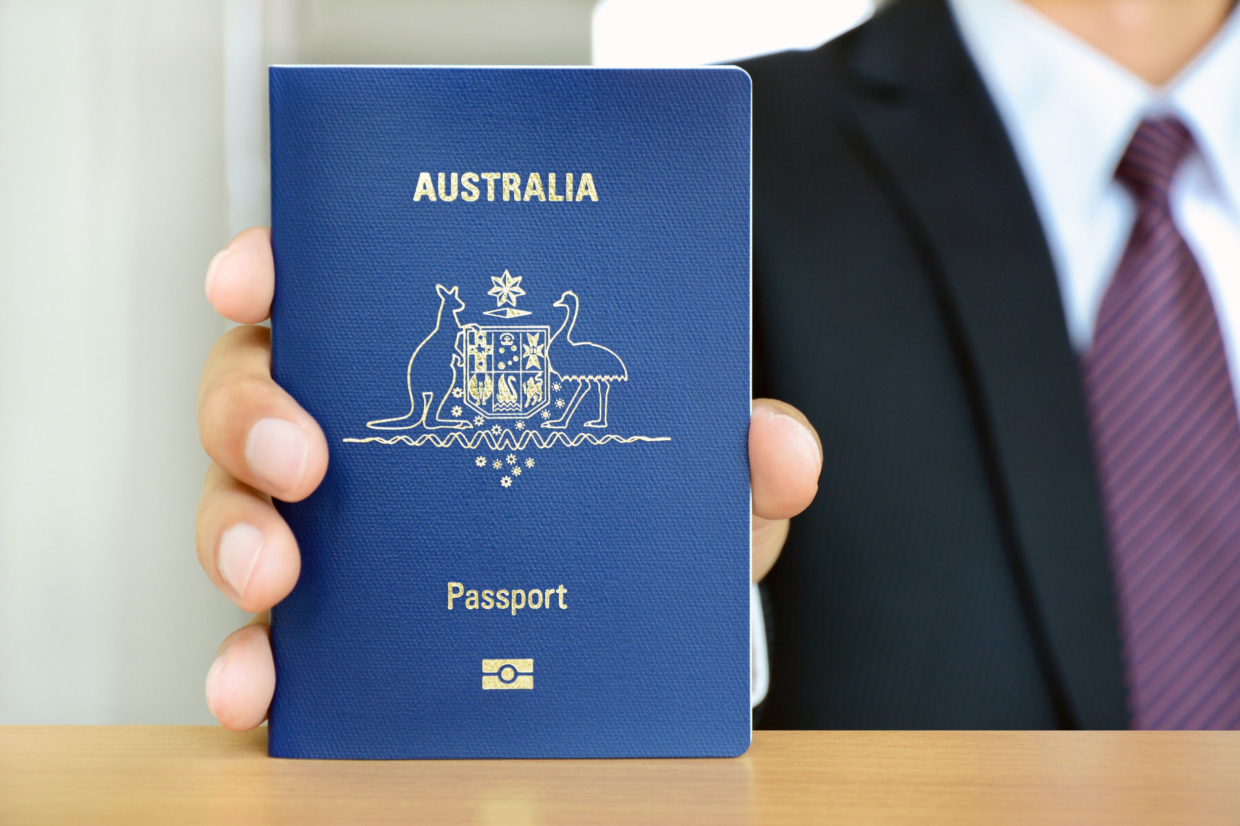 An Australian Passport Held By A Businessman
