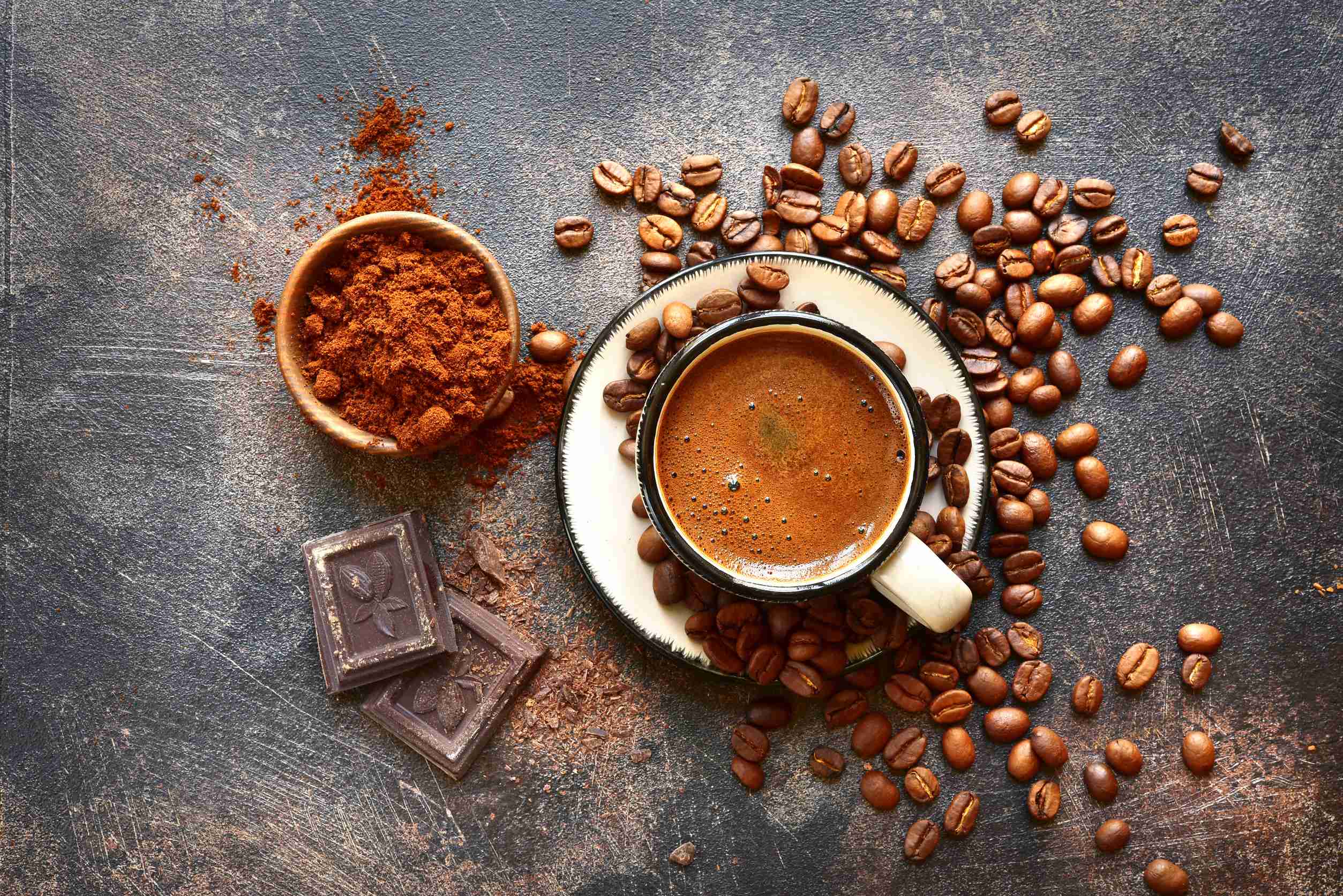 Cup of coffee with beans and cocoa
