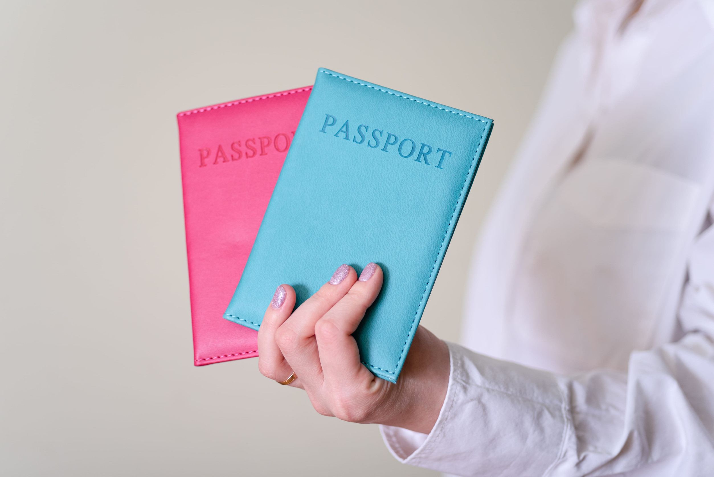 Woman Hand Holding Two Passports